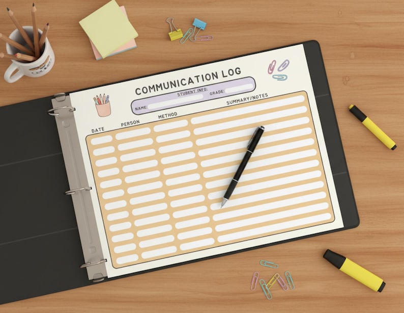 May include: A black binder open to a "COMMUNICATION LOG" page. The page has a cream background with rows of boxes for notes. A black pen rests on the page. Pencils, sticky notes, and highlighters are scattered around the binder.