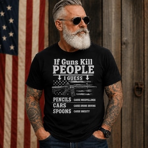 May include: A black t-shirt featuring white text that reads If Guns Kill PEOPLE I GUESS PENCILS CAUSE MISSPELLINGS CARS CAUSE DRUNK DRIVING SPOONS CAUSE OBESITY. The design includes a graphic of a rifle overlaid on a distressed American flag pattern.
