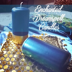 May include: Two blue pillar candles with gold bases are displayed on a gold sequined surface. The text "Enchanted Dreamspell Candles" is written in white script. The image also includes the text: "Charged with your dreams. Each candle is engraved specially for you and charged by an experienced witch."