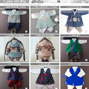 May include: Nine different styles of traditional Korean baby boy clothing, or hanbok, in various colors and patterns. The clothing is displayed on mannequins and includes jackets, vests, and pants.