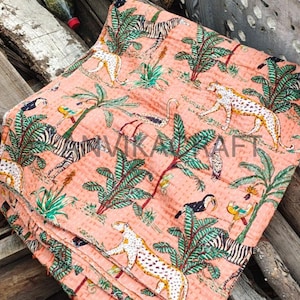 May include: A coral-colored textile featuring a repeating pattern of zebras, leopards, toucans, and palm trees. The design is hand-stitched with a detailed, textured appearance. The word "VIKARAFT" is visible in the image.