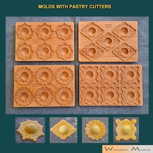 Può includere: Stampi in legno con tagliabiscotti per realizzare biscotti decorativi o ravioli. Gli stampi sono in legno e presentano una varietà di disegni. I tagliabiscotti sono anch'essi in legno e presentano una varietà di forme. Gli stampi e i tagliabiscotti sono mostrati su una superficie in legno. L'immagine mostra anche esempi dei prodotti finiti.