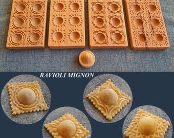 May include: Four wooden ravioli molds with different patterns, along with a wooden rolling pin. The molds are labeled "Ravioli Mignon". Four examples of ravioli made with the molds are shown below.
