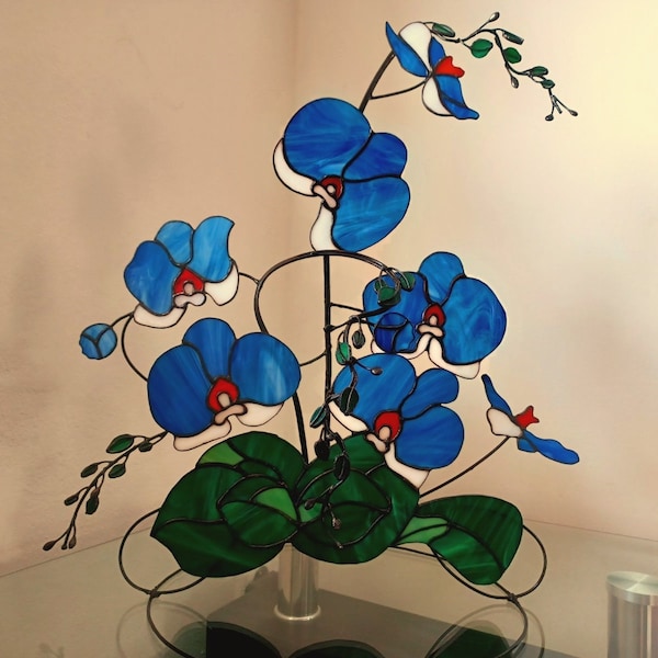 Stained glass orchid, blue glass flower white petals with plant leaves on metal stand, large sculpture, consists of several branches, 3D