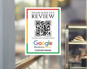 May include: A white sign with a black border and a QR code. The sign says "Please leave us a review" and "Thanks for your business!" with a Google Reviews logo and five stars. The sign also says "CUSTOM NAME".