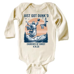 May include: A white long-sleeved baby onesie with a graphic of Jesus dunking a basketball. The text reads "Just Got Dunk'd" and "Churches of Christ 4.14.25".