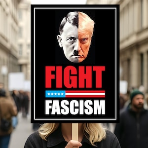May include: A person holding a sign with a black background. The sign features a split image of two faces, one side is a black and white image of Hitler, and the other side is a color image of Trump. The word "FIGHT" is in red, and "FASCISM" is in white.