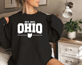 May include: Black sweatshirt with white text that reads "EST. 1803 OHIO" with a white outline of the state of Ohio underneath.
