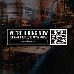 May include: Black and white sign with the text "We're Hiring Now. Jobs are posted, so apply now at www.johndoe.com". A QR code is on the right side of the sign.