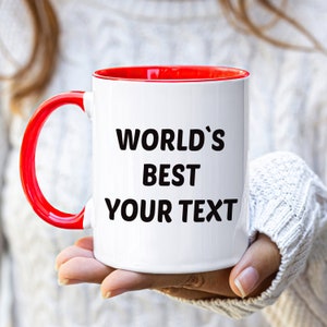 May include: White ceramic mug with a red rim and handle. The mug has black text that reads "WORLD'S BEST YOUR TEXT".