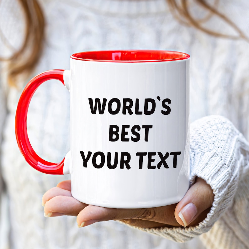 May include: White ceramic mug with a red rim and handle. The mug has black text that reads "WORLD'S BEST YOUR TEXT".