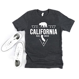 May include: A dark gray t-shirt with a white graphic design featuring a bear, a star, and the text "CALIFORNIA Est. 1850".