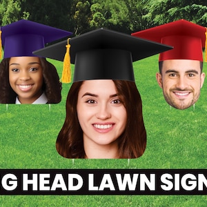 May include: Three graduation lawn signs with large heads and graduation caps. The signs feature a black cap, a red cap, and a purple cap. The text "BIG HEAD LAWN SIGNS" is at the bottom of the image.