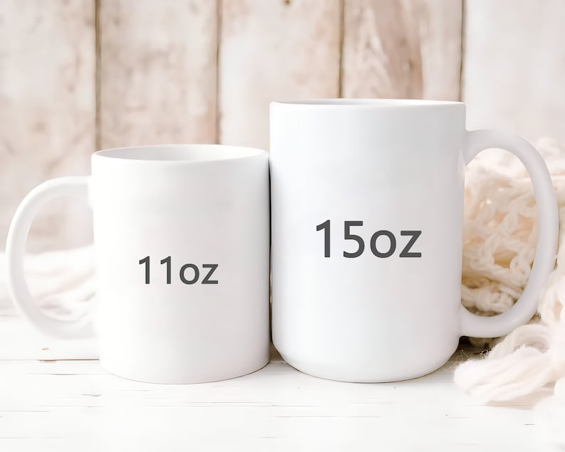 May include: Two white ceramic mugs with black text. The smaller mug is labeled "11oz" and the larger mug is labeled "15oz".