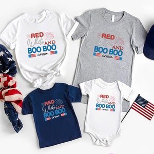 May include: A set of four shirts with the text "Red White and Boo Boo Crew" and a red, white, and blue firework graphic. The shirts are in white, gray, navy blue, and white. There is also a navy blue baseball cap and two American flags.