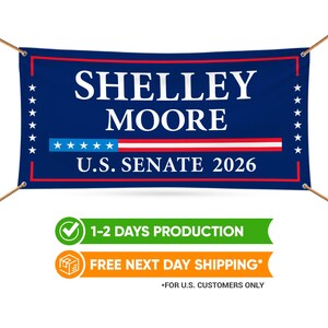 May include: A blue banner with the text "SHELLEY MOORE U.S. SENATE 2026" in white. The banner has a red border and a design resembling the American flag. The banner is held by ropes.