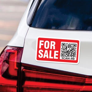 May include: A red and white car magnet with the text "FOR SALE" and a QR code with the text "SCAN ME" below it.
