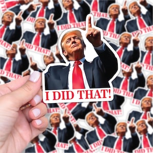 May include: A sticker featuring a man in a black suit and red tie pointing upwards, with the text "I DID THAT!" in red. The image is repeated multiple times, with a hand holding one sticker.