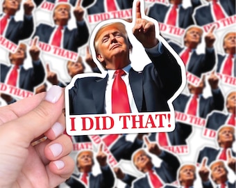 May include: A sticker featuring a man in a black suit and red tie pointing upwards, with the text "I DID THAT!" in red. The image is repeated multiple times, with a hand holding one sticker.