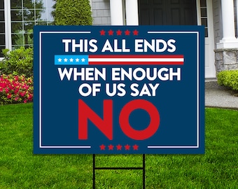 May include: A blue yard sign with white border and the text "THIS ALL ENDS WHEN ENOUGH OF US SAY NO" in white and red. The sign has a red, white, and blue design and is displayed on a metal stake in a grassy yard.