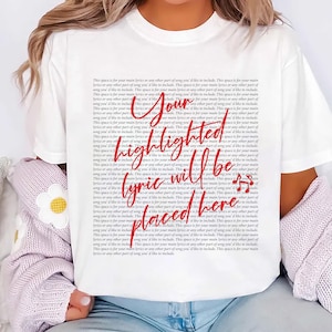 May include: A white short-sleeved t-shirt featuring a background of repeated black text that reads, "This space is for your main lyrics or any other part of song you'd like to include." Overlaid in red script is the text, "Your highlighted lyric will be placed here."