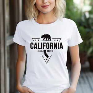 May include: White t-shirt with a black graphic design featuring a bear walking, a star, and the text "CALIFORNIA Est. 1850".