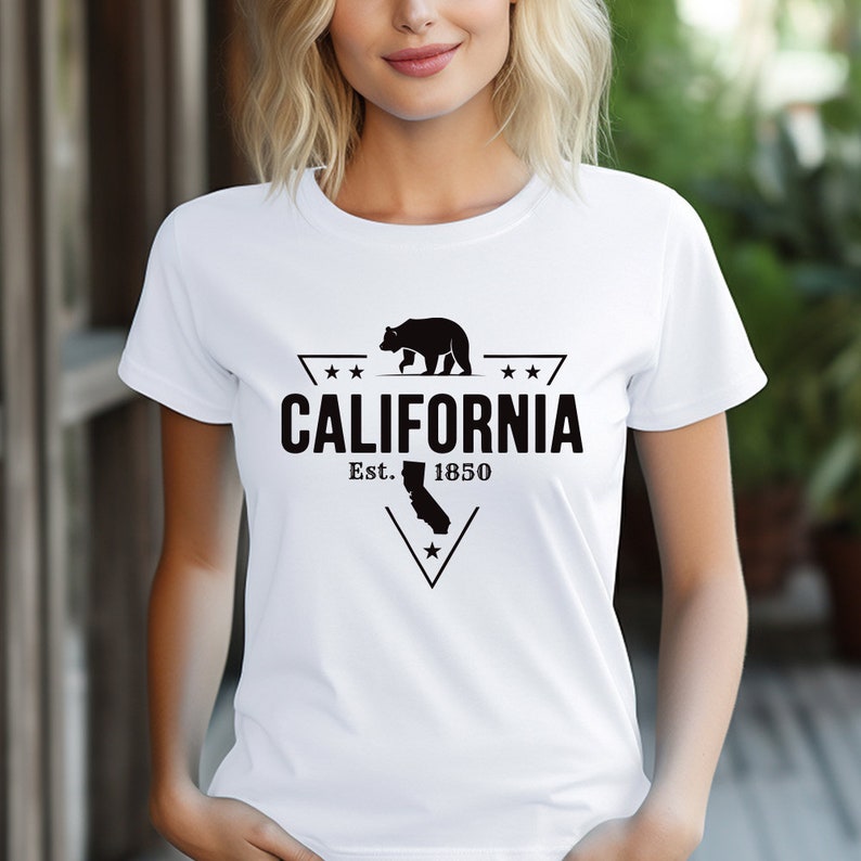May include: White t-shirt with a black graphic design featuring a bear walking, a star, and the text "CALIFORNIA Est. 1850".