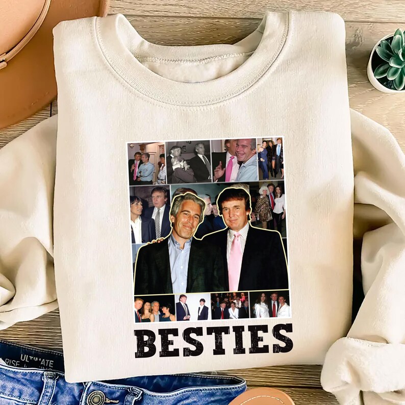 May include: Cream-colored sweatshirt featuring a collage of images and the word "BESTIES" in bold, black letters. The collage includes photos of two men. The sweatshirt is made of a soft material and has a crew neck.