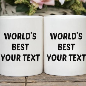 May include: Two white ceramic mugs with black text that reads "World's Best Your Text".