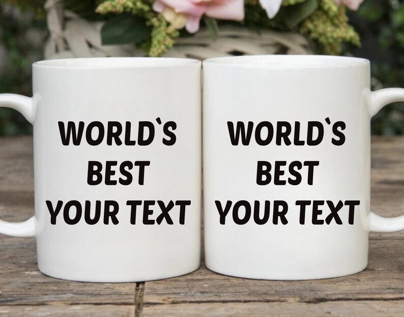 May include: Two white ceramic mugs with black text that reads "World's Best Your Text".