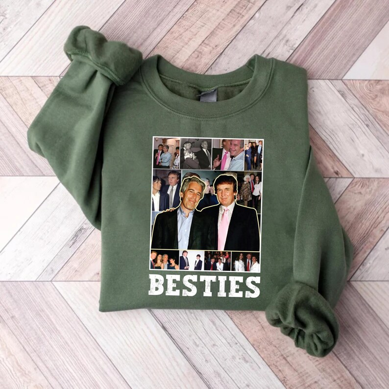 May include: Green sweatshirt with a collage of photos and the word "BESTIES" in white. The collage features two men in suits. The sweatshirt is made of a soft material and has long sleeves.