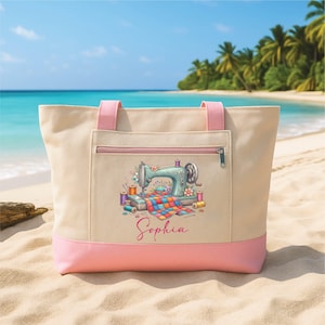 May include: A beige tote bag with pink accents, featuring a sewing machine design. The bag has a pink zipper pocket and handles. The design includes a vintage sewing machine, spools of thread, and the name "Sophia".