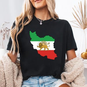 May include: Black t-shirt featuring a graphic of the Iran map in green, white, and red, with a lion and sun emblem. The shirt is a casual style, suitable for everyday wear.