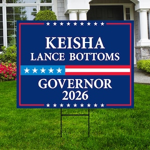 May include: A blue lawn sign with the name "KEISHA LANCE BOTTOMS" and the title "GOVERNOR 2026" in white text. The sign has a red border and a section with stars and stripes.