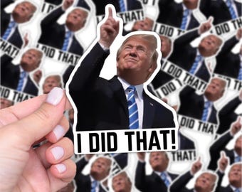 May include: A white sticker featuring a man in a black suit and blue tie pointing upwards. The sticker has the text "I DID THAT!" in bold, black letters. The background is filled with similar stickers.