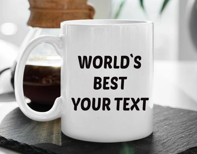 May include: White ceramic mug with black text that reads "WORLD'S BEST YOUR TEXT".