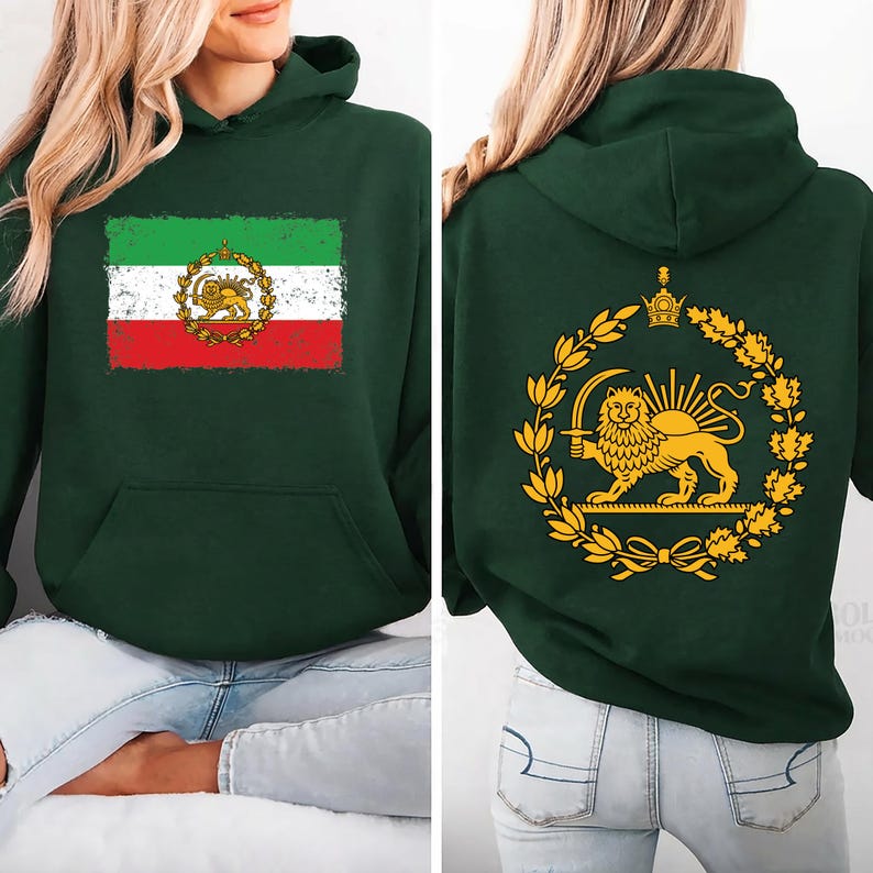 May include: Dark green hoodie featuring the Iranian flag on the front and a golden lion emblem on the back. The flag design includes green, white, and red stripes with a lion and sun emblem. The back displays a golden lion and sun emblem within a wreath.