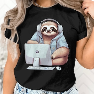 May include: A black t-shirt with a graphic of a sloth wearing headphones and using a computer. The sloth is wearing a blue hoodie and has a light blue background.