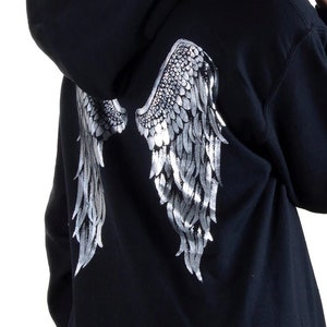 May include: Black hooded sweatshirt with a silver glitter angel wing design on the back.