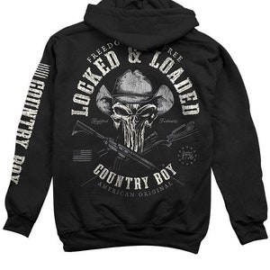May include: Black hooded sweatshirt with a skull wearing a cowboy hat and crossed rifles. The text "Locked & Loaded" is above the skull and "Country Boy" is below the skull. The text "Freedom" and "Free" are on either side of the skull. The text "American Original" is below "Country Boy".
