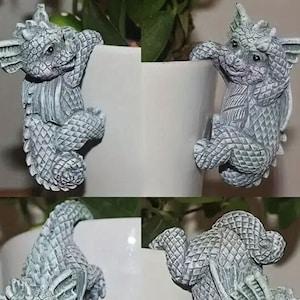 May include: Four gray ceramic dragon figurines are climbing up the sides of white ceramic flower pots. The dragons have detailed scales and are in various poses.