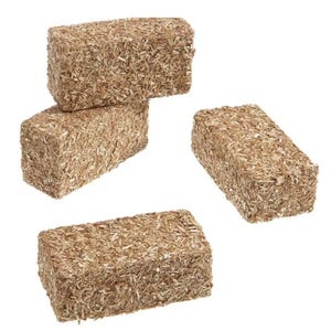 May include: Four rectangular blocks made of compressed, light brown wood fibers. The blocks are arranged in a scattered pattern against a white background. The texture of the blocks appears rough and natural.