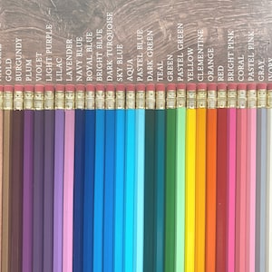May include: A set of 30 wooden pencils with different colored paint on the body. The pencils are arranged in a row from left to right, with the colors black, natural, gold, burgundy, plum, violet, light purple, lilac, lavender, navy blue, royal blue, bright blue, dark turquoise, sky blue, aqua, pastel blue, dark green, teal, green, pastel green, yellow, clementine, orange, red, bright pink, coral, pastel pink, gray, ivory, and white.