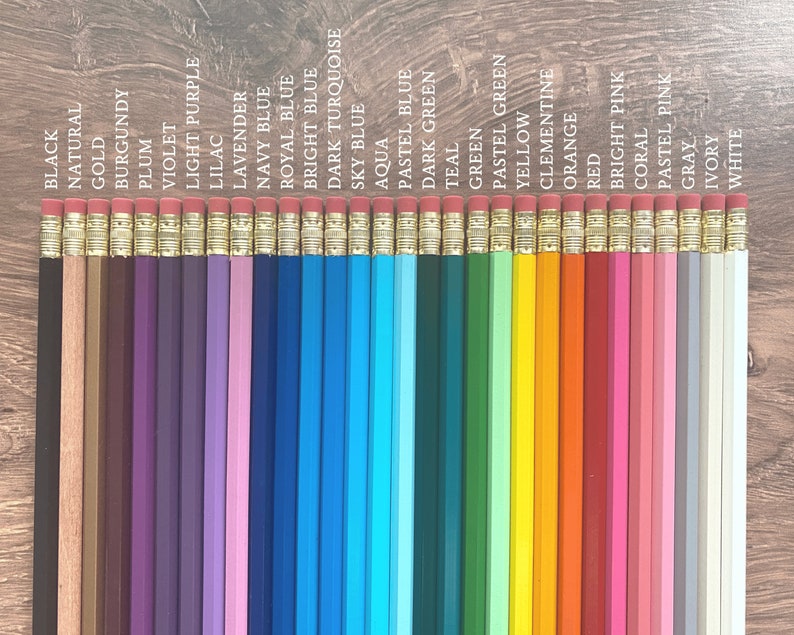 May include: A set of 30 wooden pencils with different colored paint on the body. The pencils are arranged in a row from left to right, with the colors black, natural, gold, burgundy, plum, violet, light purple, lilac, lavender, navy blue, royal blue, bright blue, dark turquoise, sky blue, aqua, pastel blue, dark green, teal, green, pastel green, yellow, clementine, orange, red, bright pink, coral, pastel pink, gray, ivory, and white.