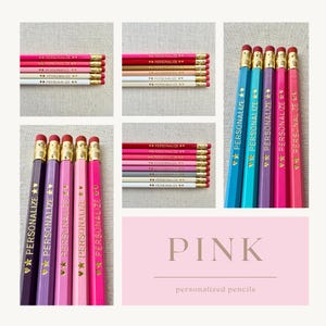 May include: A collection of pencils in various shades of pink, purple, and white, each featuring gold-colored metal ferrules and erasers. The pencils are imprinted with the word PERSONALIZE and star symbols in gold foil. A pink graphic panel displays the text PINK personalized pencils.
