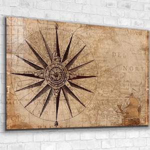 May include: A vintage compass rose with a detailed design on a weathered map background. The compass points to the north, south, east, and west. The map shows the text "MAR DEL NORTE" and "Antillas Is."
