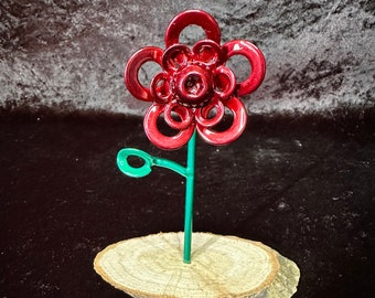 Nut and bolt flower. Metal daisy mounted in wood