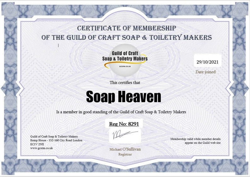 May include: A certificate of membership from the Guild of Craft Soap & Toiletry Makers, featuring a blue decorative border. The certificate states "Soap Heaven" as a member, with the date 29/10/2021. The document includes the Guild's logo.