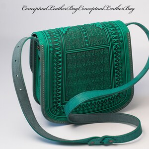 May include: A teal green leather shoulder bag with a geometric pattern and a long adjustable strap.  The bag has a flap closure and a small pocket on the front.