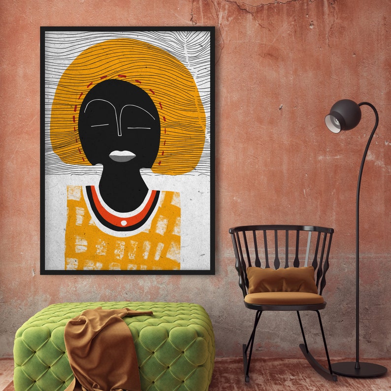 May include: Abstract art print featuring a stylized black figure with closed eyes and a yellow halo-like shape. The figure wears a yellow and orange patterned top. The artwork is framed in black and hangs on a textured red wall.